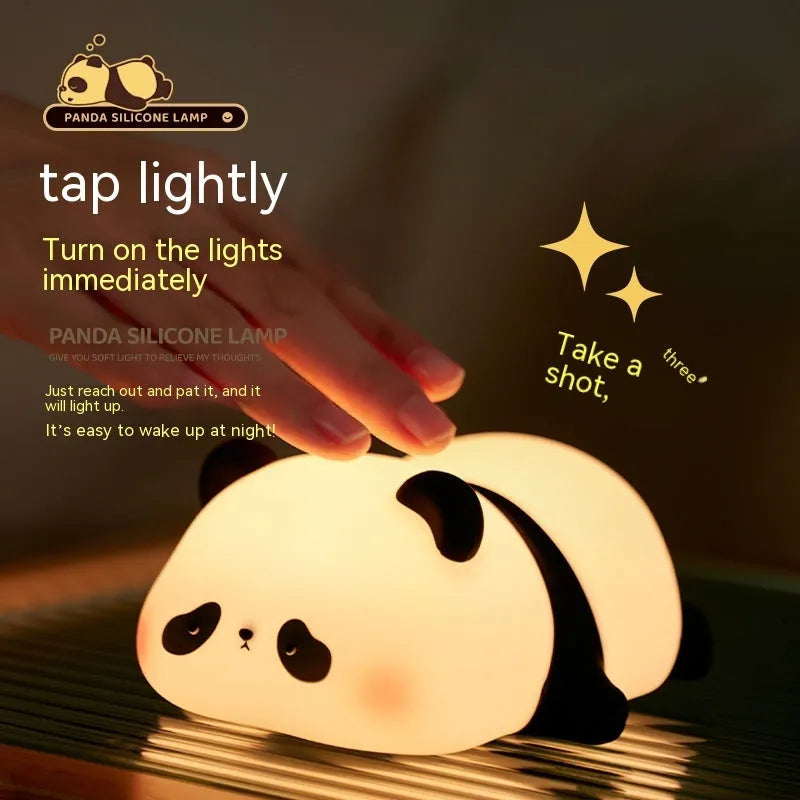Cute cartoon panda-shaped silicone night light sitting on a surface, showing its soft glow.