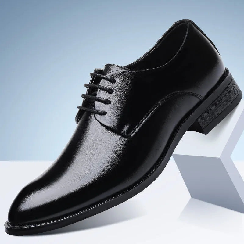 Men's black leather dress shoes with low heel, front strap, sewing thread detailing, and adhesive rubber sole