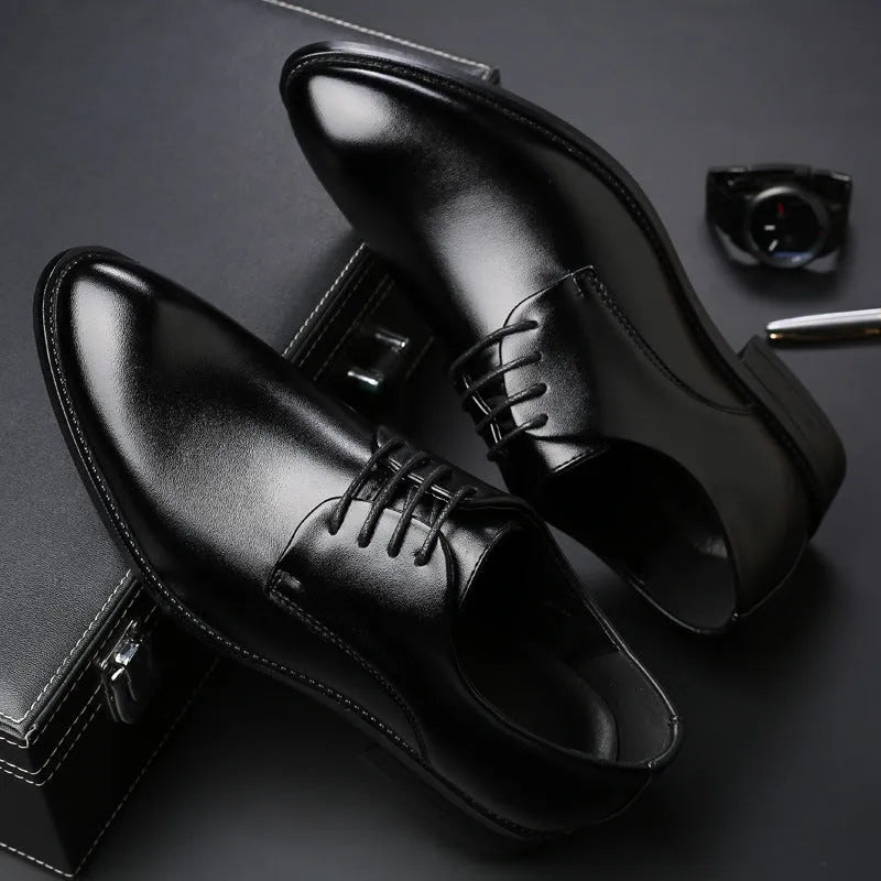 Men's black leather dress shoes with low heel, front strap, sewing thread detailing, and adhesive rubber sole