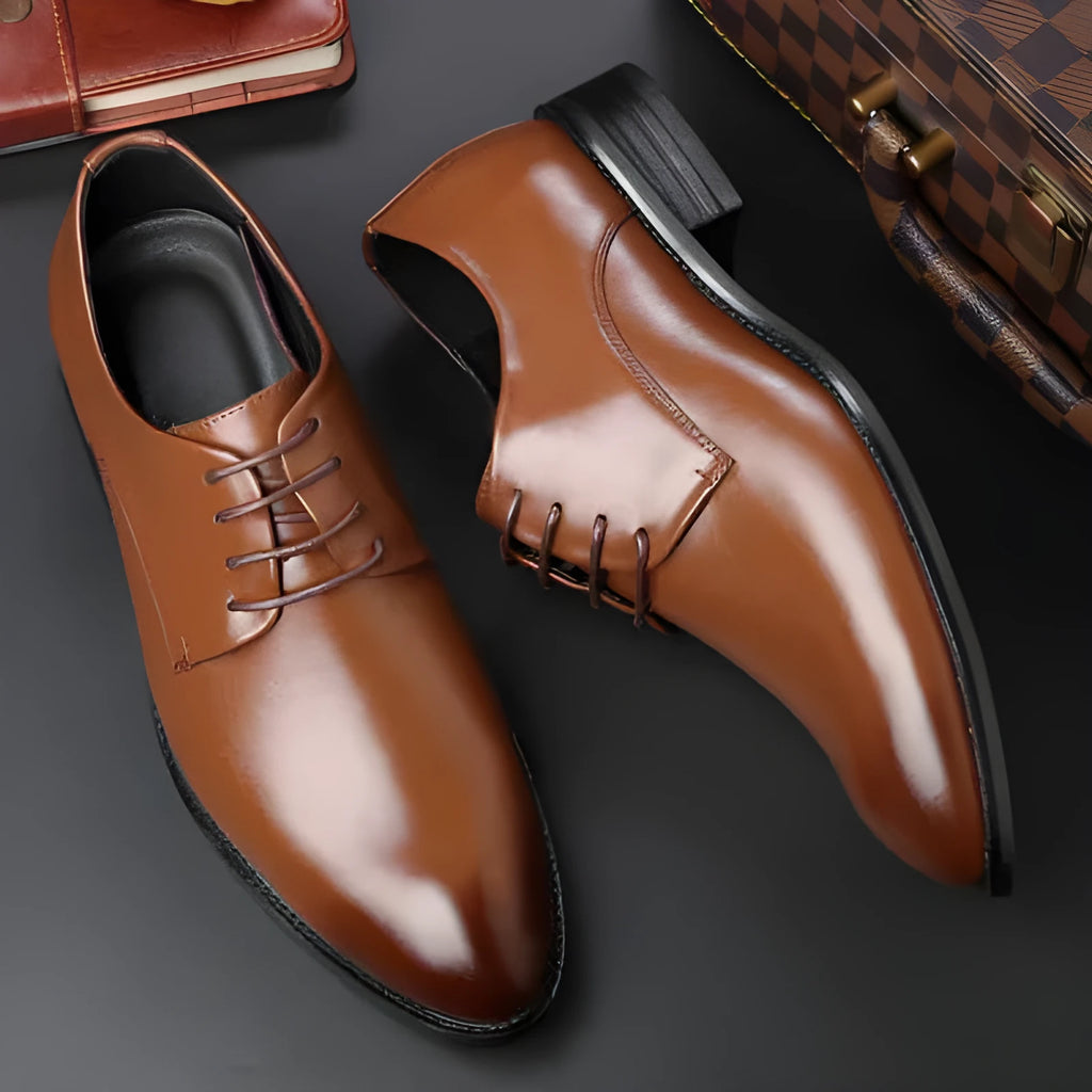 Men's black leather dress shoes with low heel, front strap, sewing thread detailing, and adhesive rubber sole