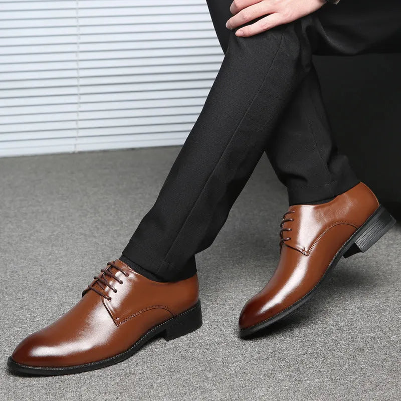 Men's black leather dress shoes with low heel, front strap, sewing thread detailing, and adhesive rubber sole