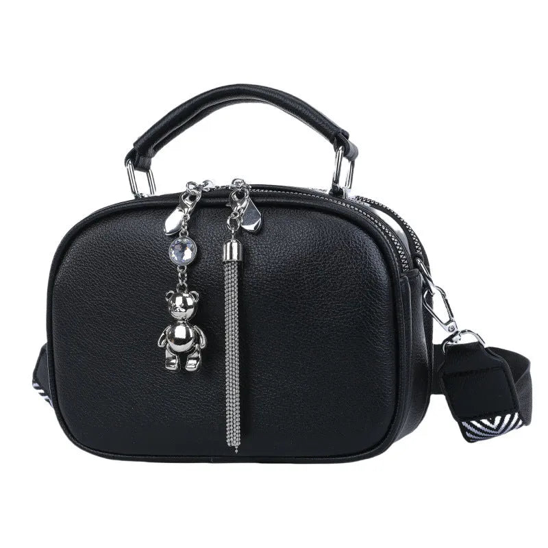 Oval-shaped women's small square shoulder bag in PU with double straps, shown in blue.