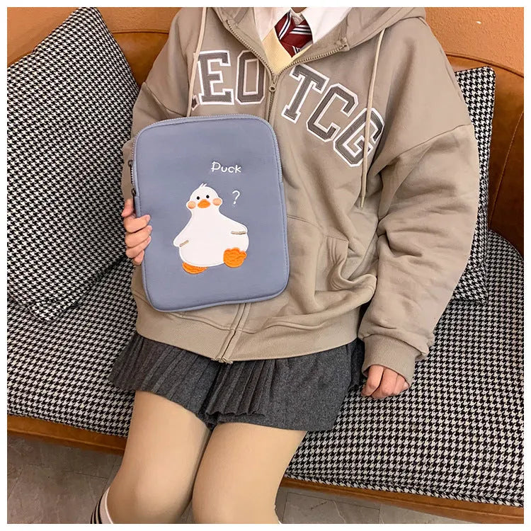 Blue cotton tablet case with embroidered cartoon duck design and a zipper closure.
