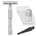 Old style manual double-sided safety razor with chrome alloy handle and 10 replacement blades on a towel.