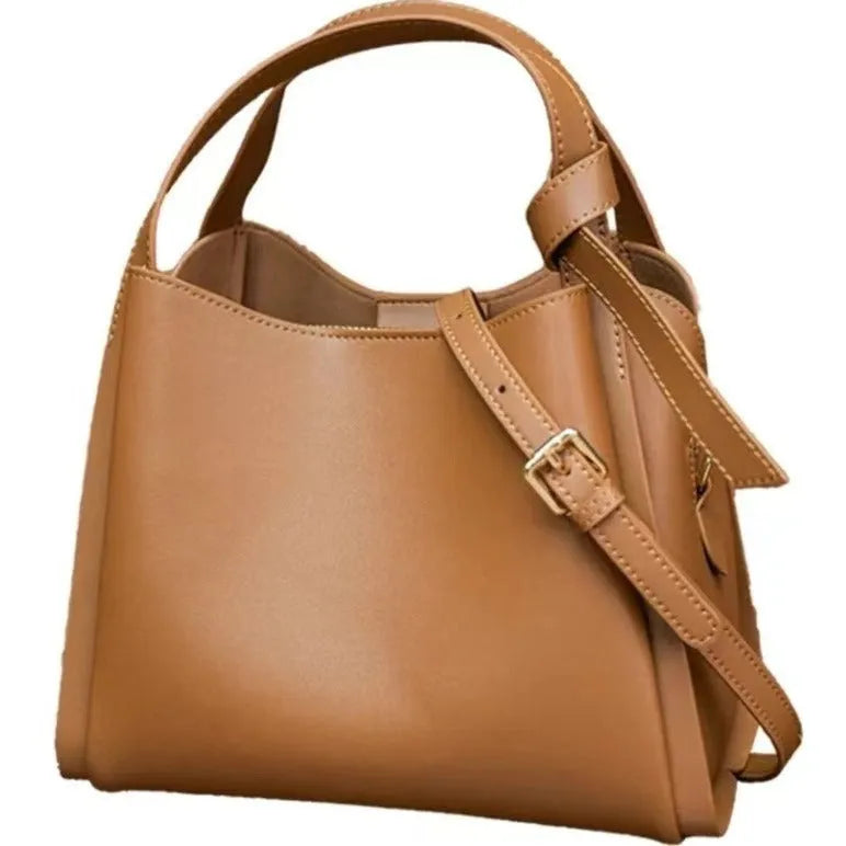 Genuine leather women's crossbody bag in tea brown showing bucket shape and crossbody strap