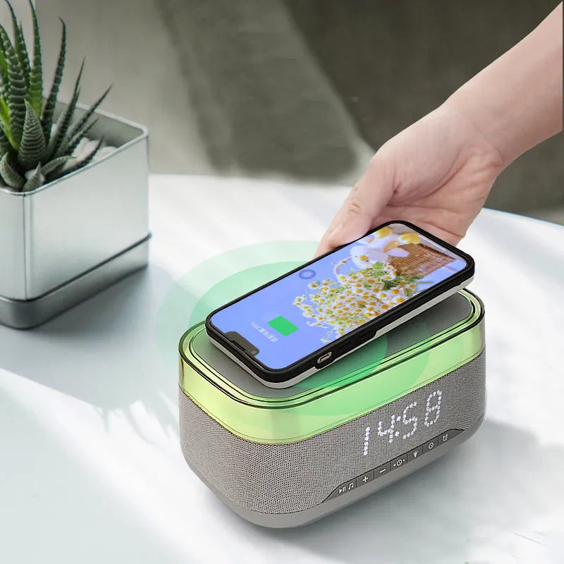 White multifunctional alarm clock with Bluetooth speaker and wireless charging pad on a bedside table.