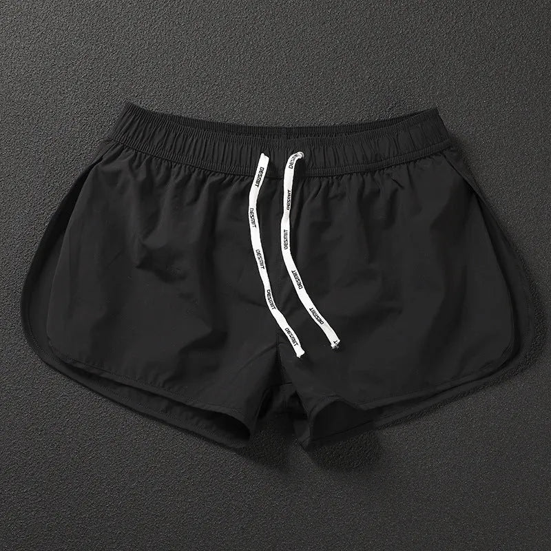 Men's loose polyester surfing shorts in orange, fluorescent green, or black on a size chart.