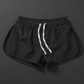 Men's loose polyester surfing shorts in orange, fluorescent green, or black on a size chart.