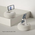 Adjustable rotating phone and tablet bracket on a desk, showing the clamp and fabric base.