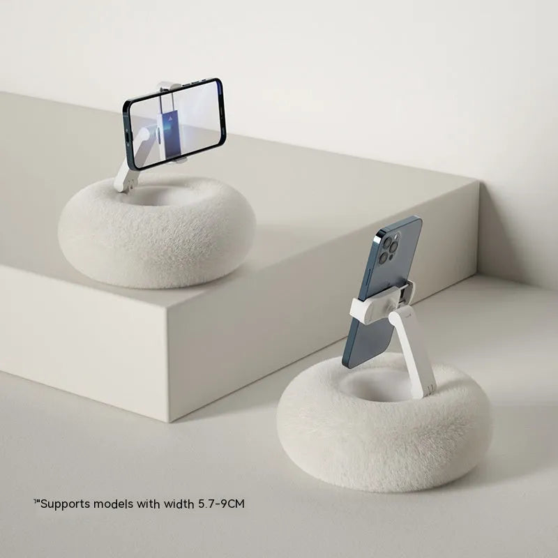 Adjustable rotating phone and tablet bracket on a desk, showing the clamp and fabric base.