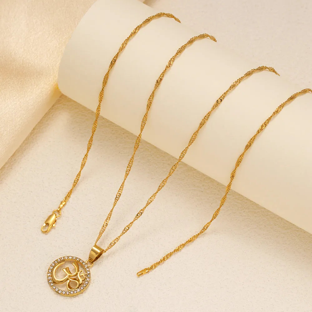 Gold plated copper necklace with circular OM pendant and inlaid stones