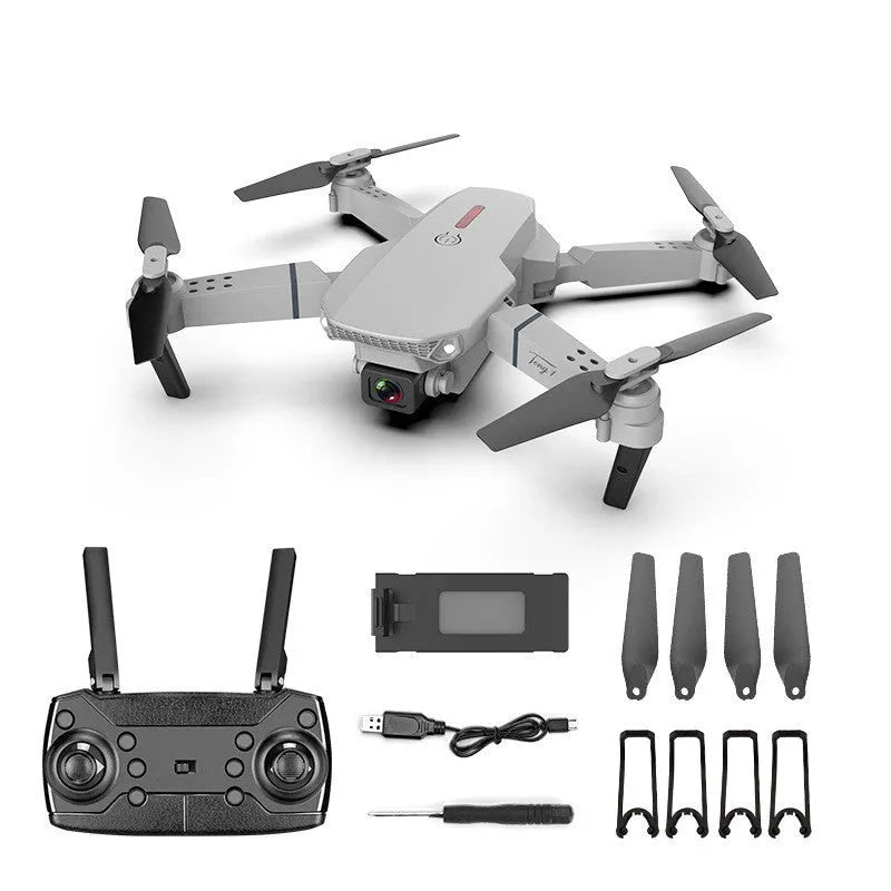 Grey foldable 4K dual camera drone with remote controller on a table.