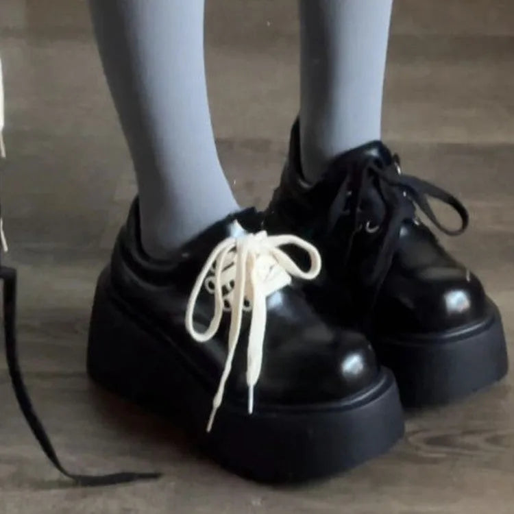 Matte black women's lace-up high-heel shoes with a thick sole and an English muffin heel.