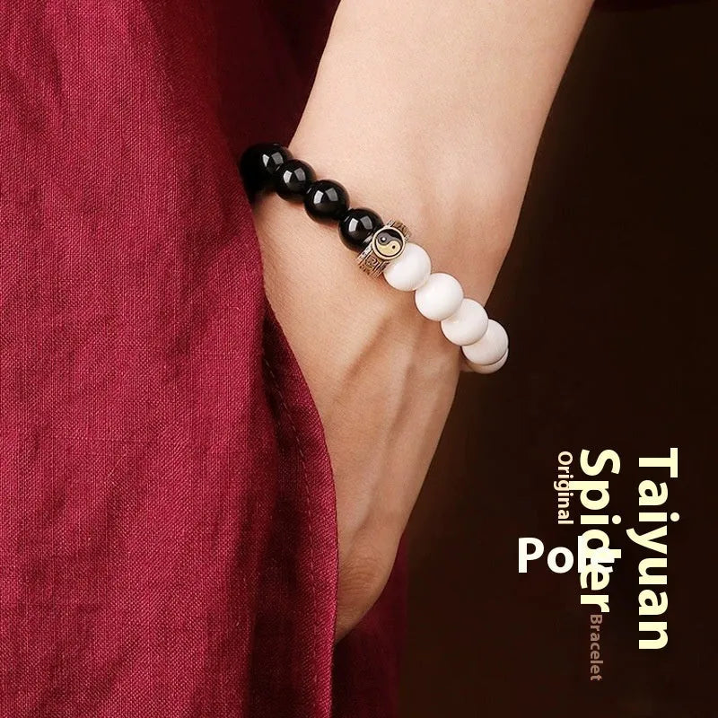 Black and white obsidian tai chi bracelet with 10mm geometric beads and bodhi mantra design