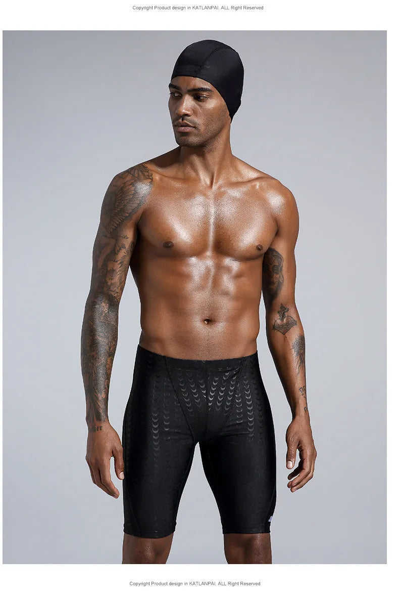 Men's solid colour swimming trunks in shark skin polyester fabric for surfing.