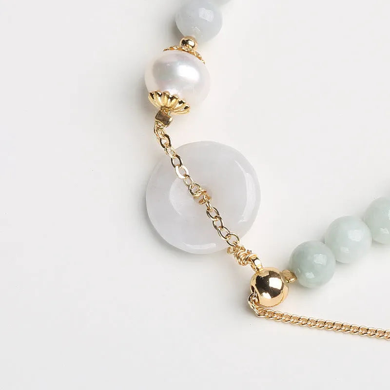 Handcrafted jade pearl bracelet with peace buckle closure in traditional Chinese style
