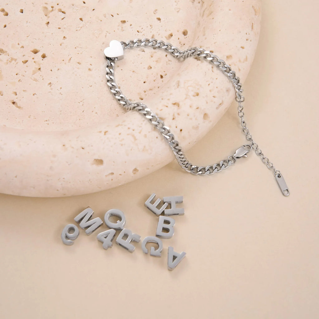 Gold or silver plated titanium steel necklace with a personalised letter, number, or heart pendant on a 40.5cm chain.