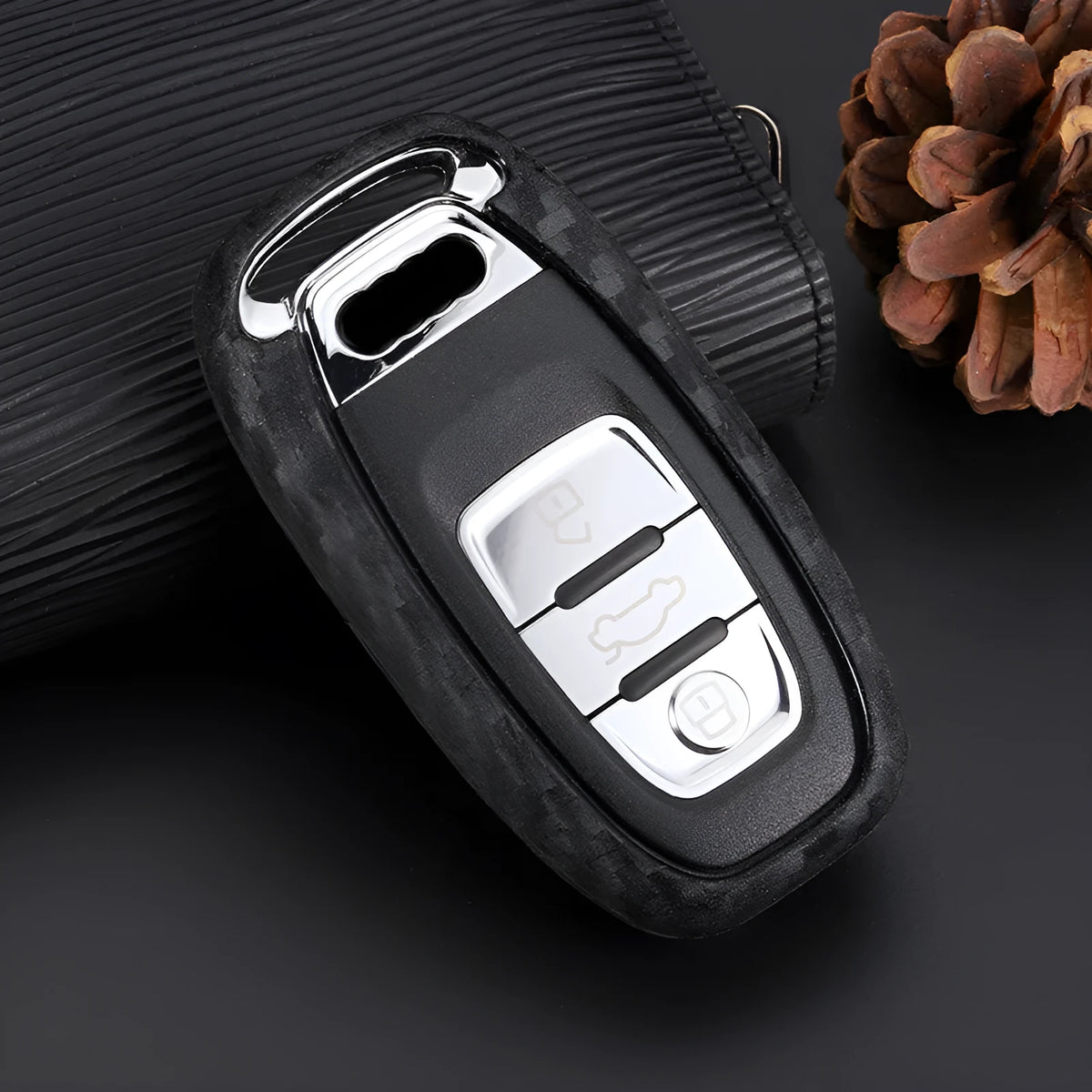 Carbon fibre silicone car key case in round button, single key or square key style, shown as a protective cover for car keys