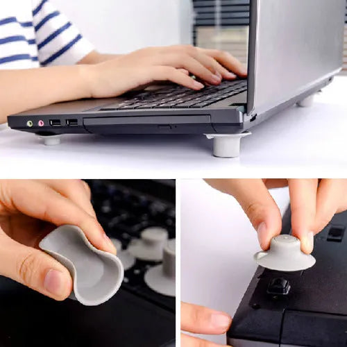 Grey plastic laptop cooling pad stand with four non-slip pads on a desk.