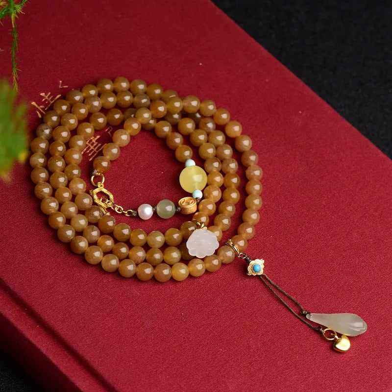 Women's green jade bead bracelet with leaf motifs and sequin details