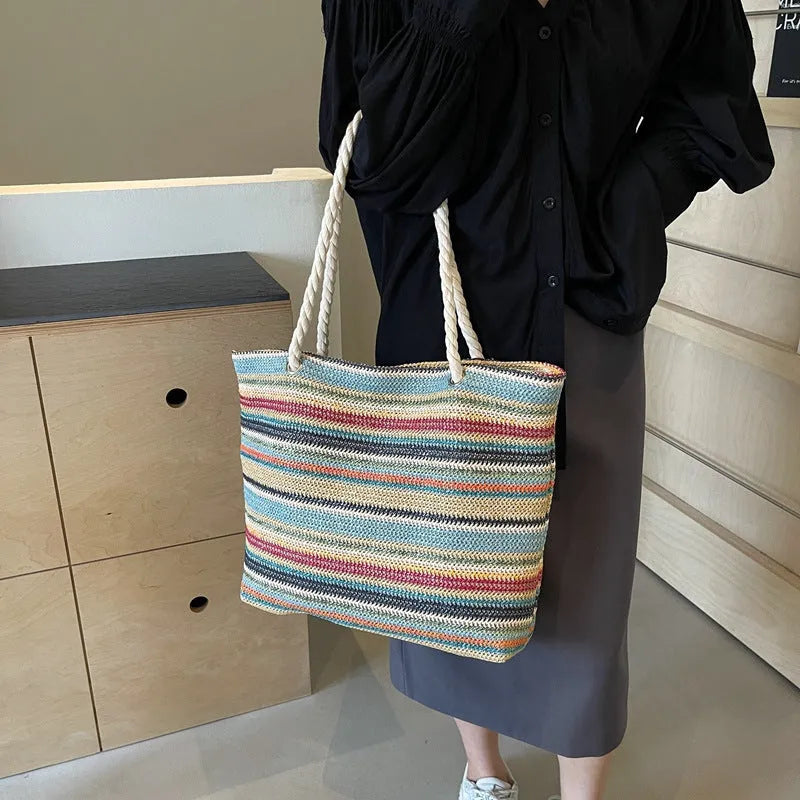 Blue woven nylon shoulder bag with single strap and straw texture.