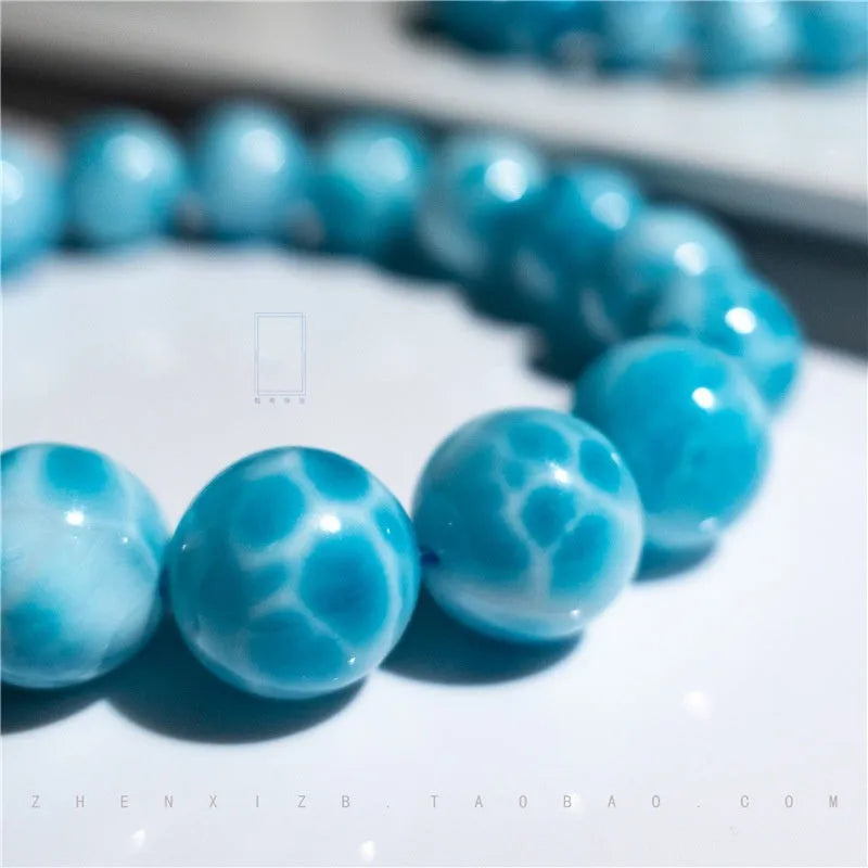 Blue handmade Bodhi bracelet with natural crystal stones and pearl accents in Maillard style.
