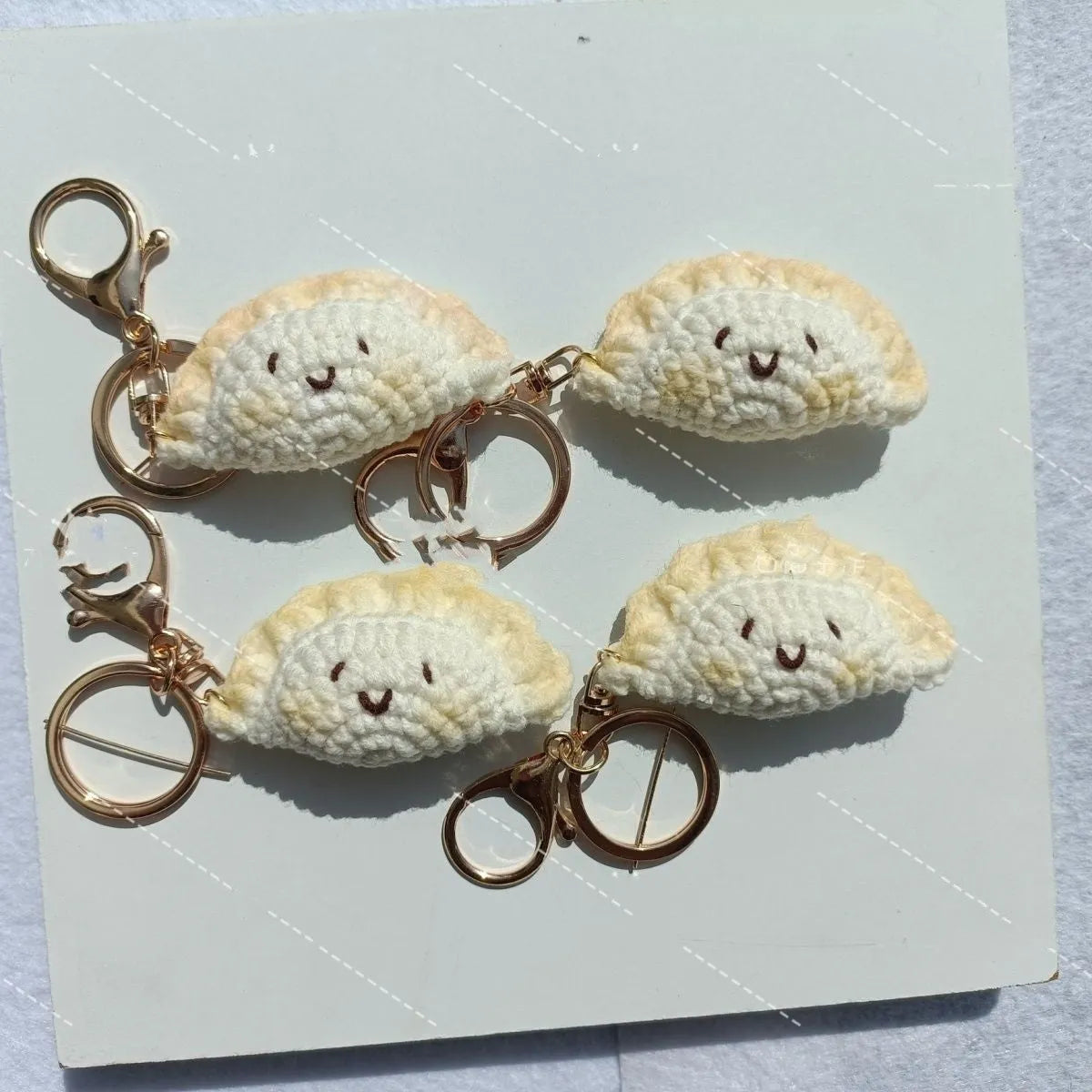 Handmade crochet plush dumpling pendant with keychain in traditional Spring Festival design.