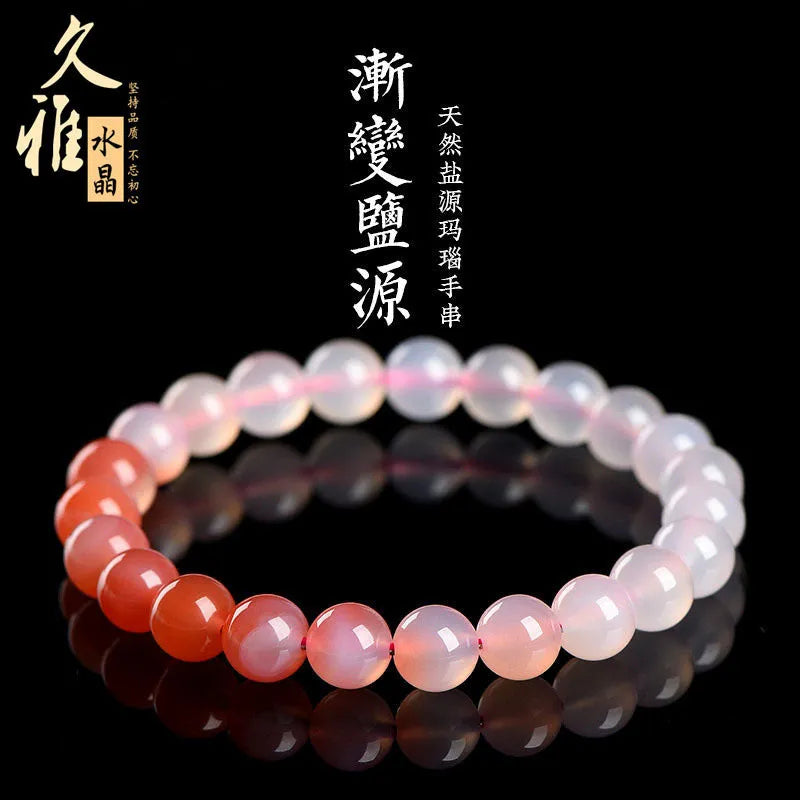 Natural gradient Yanyuan agate bracelet with geometric beads on a wrist, showing salt source colour variation.