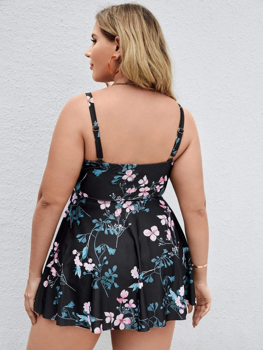 Women's floral print one-piece swimsuit with split colours, shown on a model.