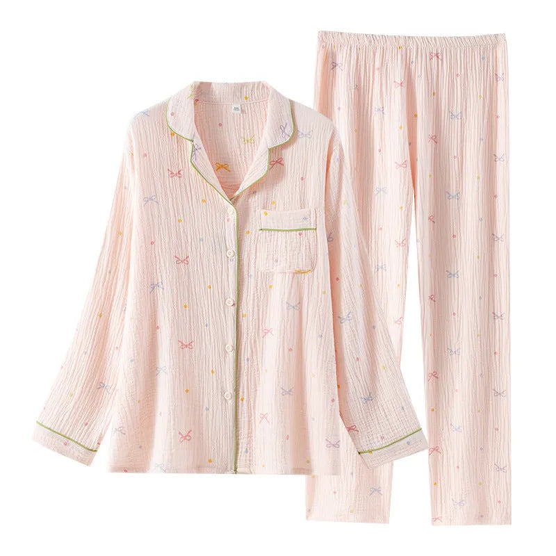 Women's beige long-sleeved cotton pajama top and trouser set laid flat.