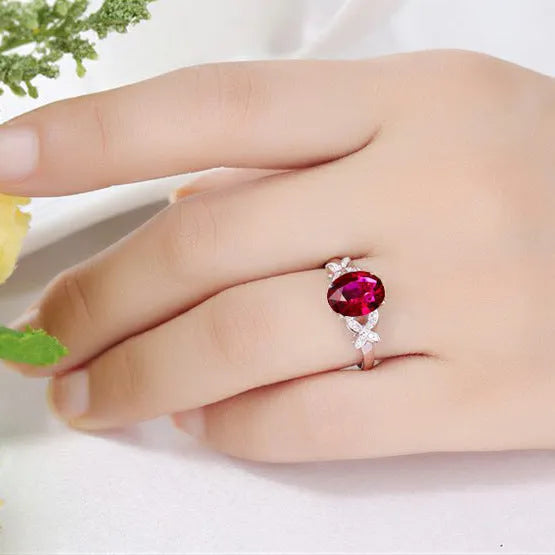 Women's butterfly ring with heart-shaped design in copper and rose gold plating, showing blue and red colour options