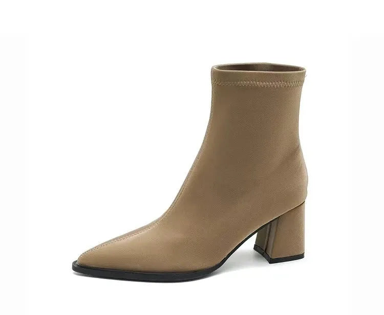 Women's khaki pointed toe Martin boots with a wedge heel on a rubber sole.