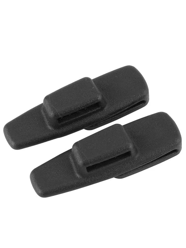 Two black ABS plastic car seatbelt stopper clips for adjusting length and preventing neck pinch.