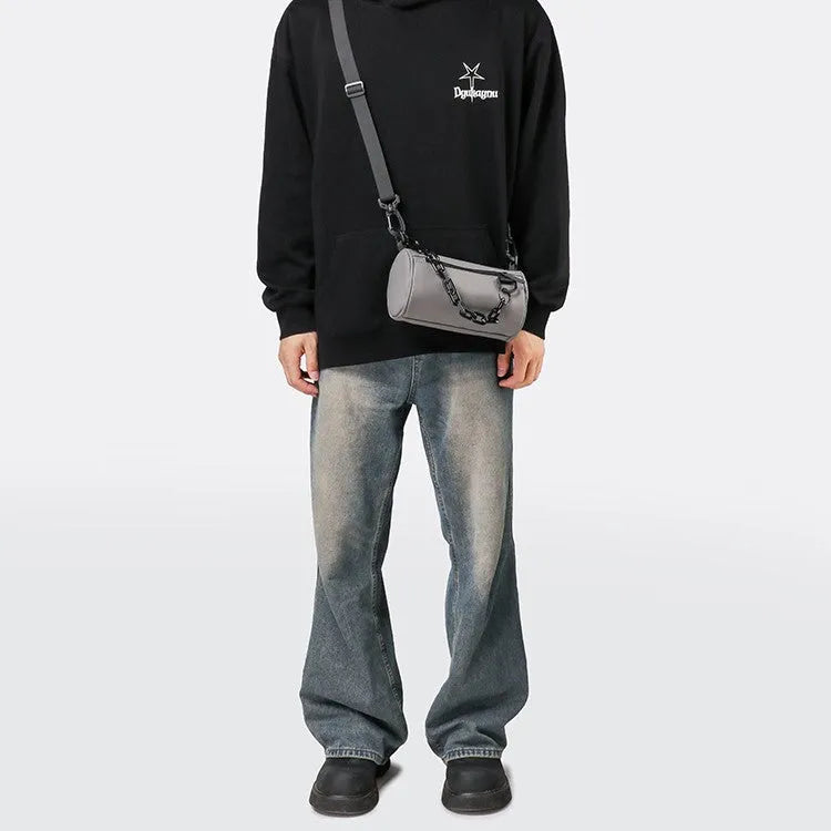 Black waterproof Oxford cloth messenger bag with a chain detail, shown as a crossbody bag.