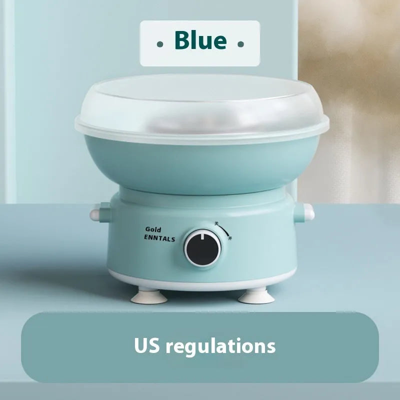 Mini cotton candy machine in blue with metal body and round heating tube on a countertop