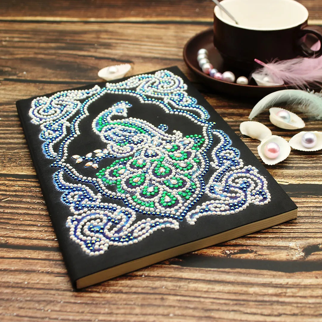 Black A5 diamond painting notebook with a peacock design, shaped drills, and OPP packaging.