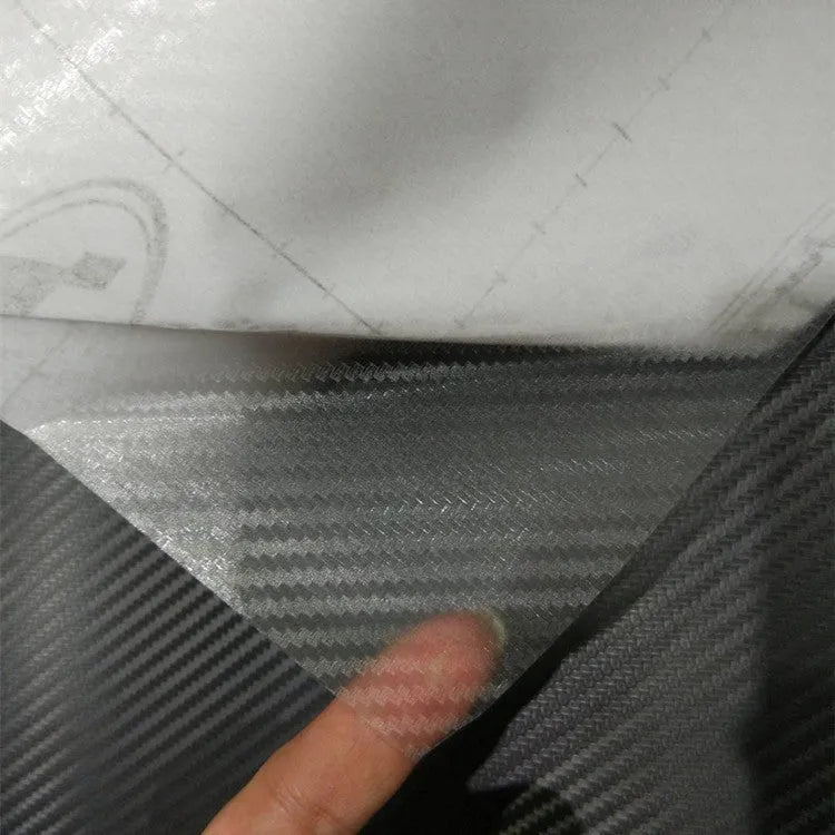Roll of black car carbon fiber sticker 127x30cm with foam stick on car trim