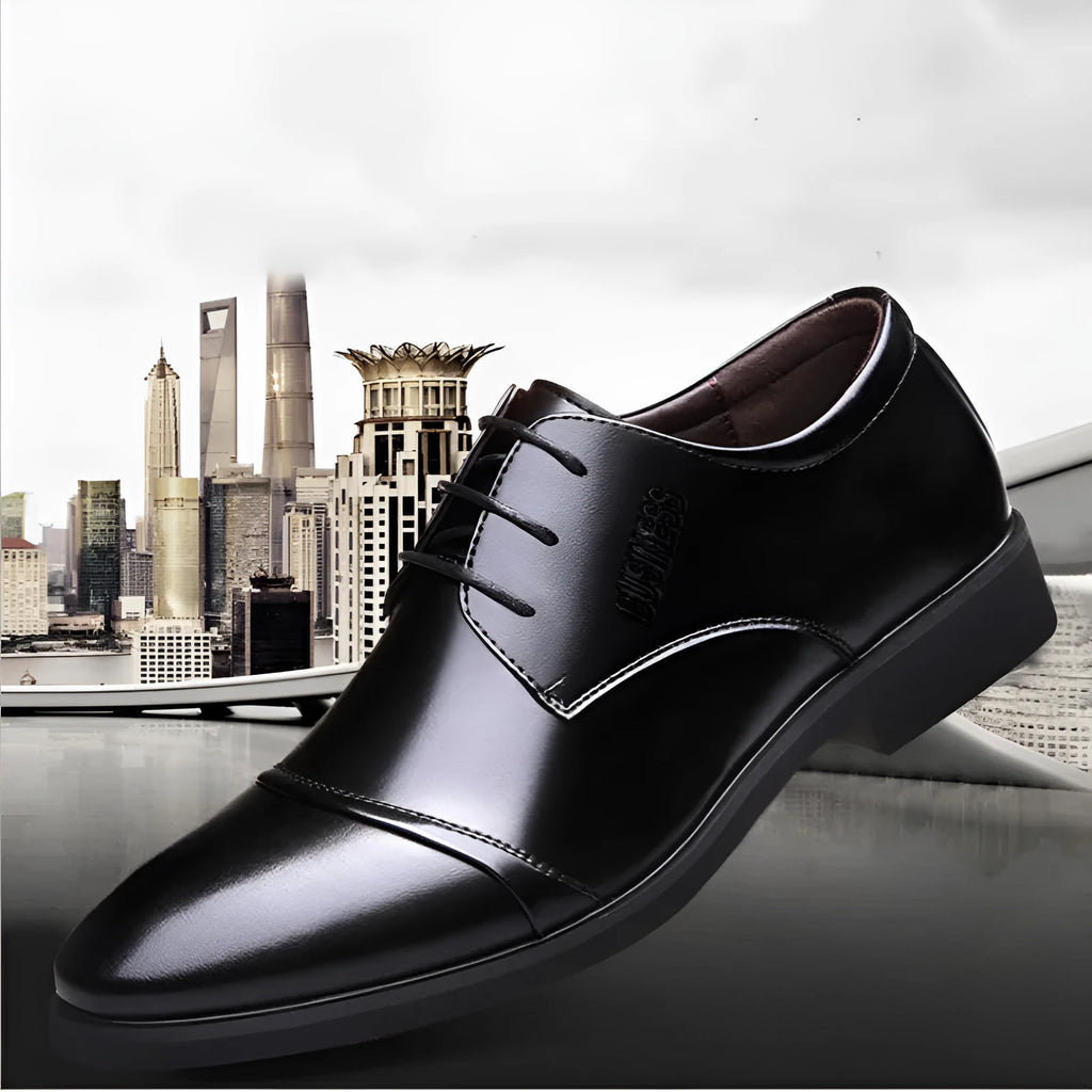 Men's black formal lace-up shoe with decorative stitching and a horse buckle on a rubber sole.