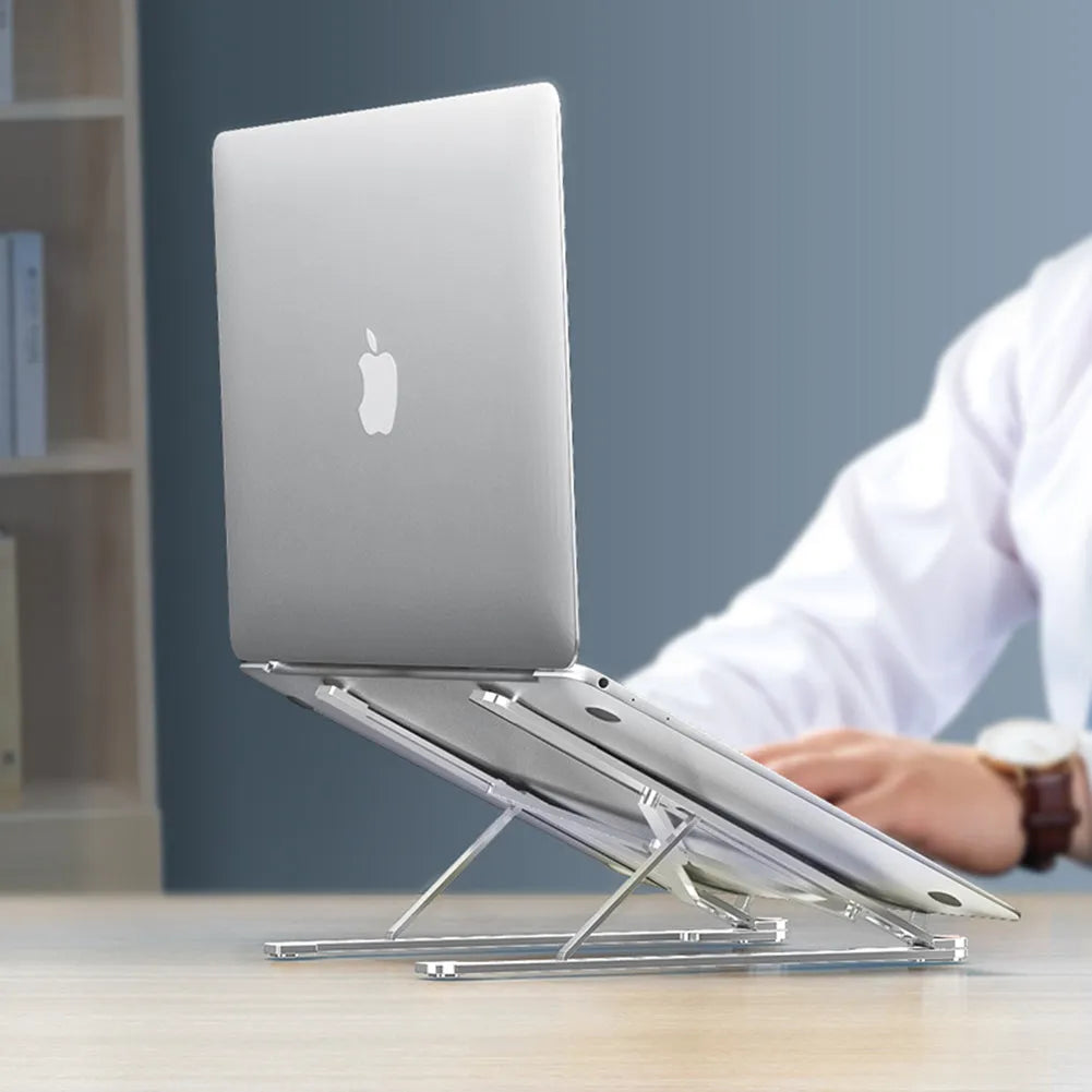 Aluminium foldable laptop stand in silver colour, shown elevated with a laptop on top