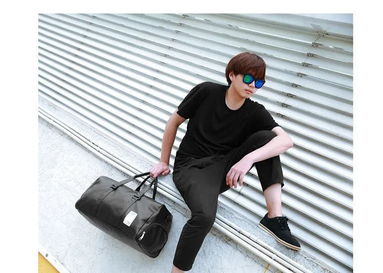 Black waterproof sports bag with separate side shoe compartments and diagonal shoulder straps