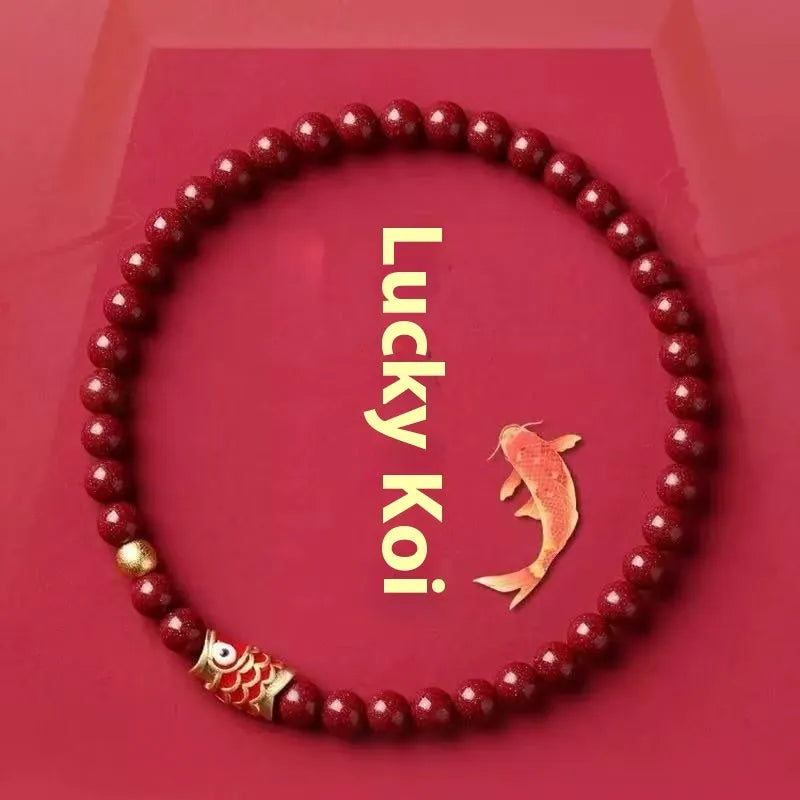 Handmade natural cinnabar koi bracelet with gold balls on a bead, showing traditional Chinese style.