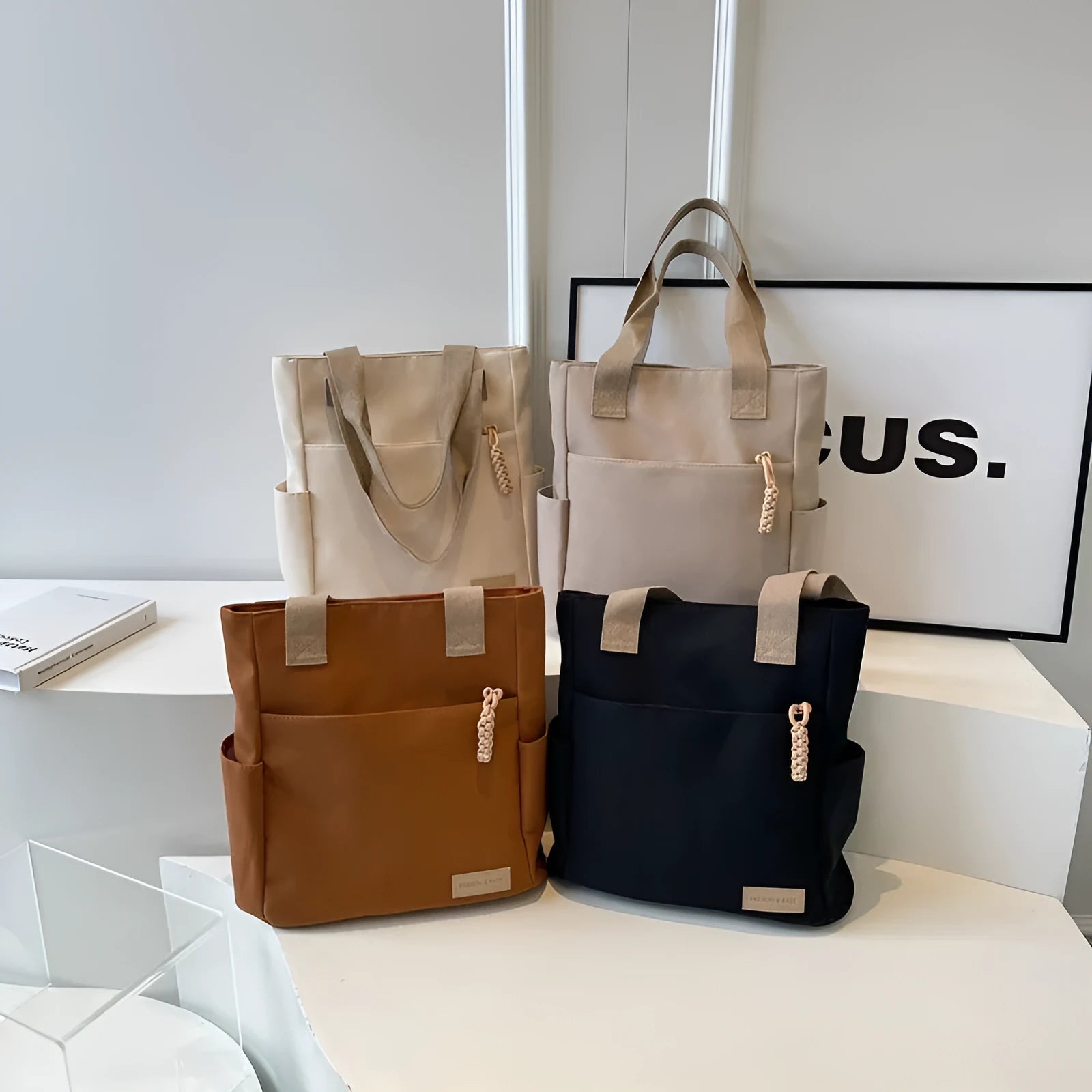 Women's large canvas satchel in beige with shoulder strap, horizontal square shape, and visible sewing thread details