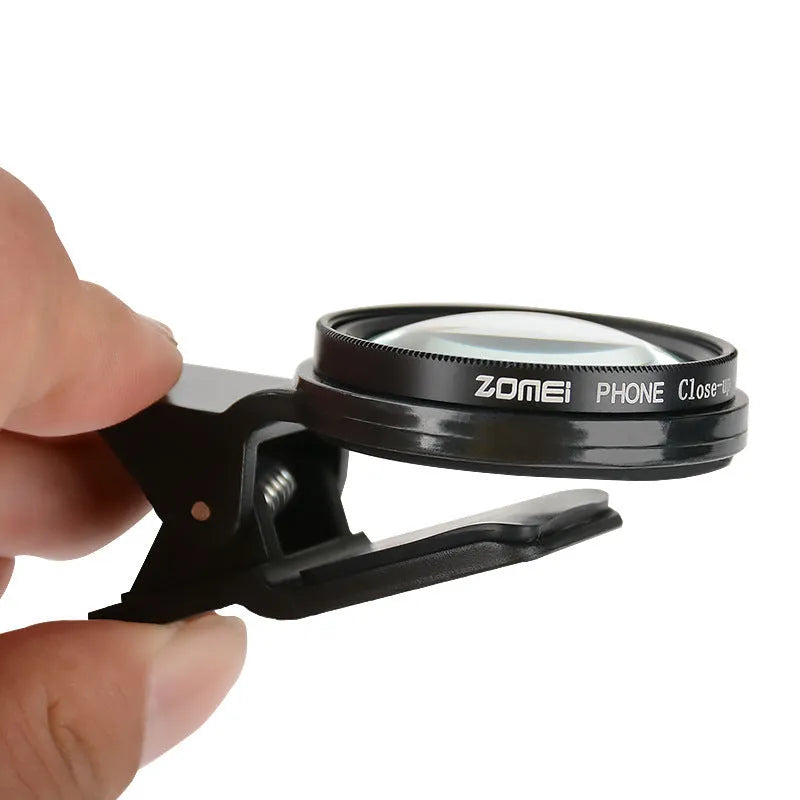 Smartphone macro close-up lens with aluminium frame and clip attachment on white background.