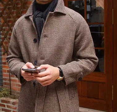 Mid-length brown wool coat with shoulder insert on a hanger, leisure style with structured shoulders