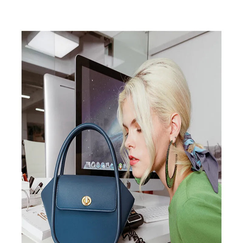 Women's leather wing shape tote bag with cross-body strap in four colour options showing buckle detail