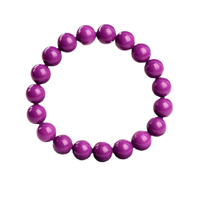 Close-up of a polished purple mica crystal bracelet with a single ring of beads on a wrist.