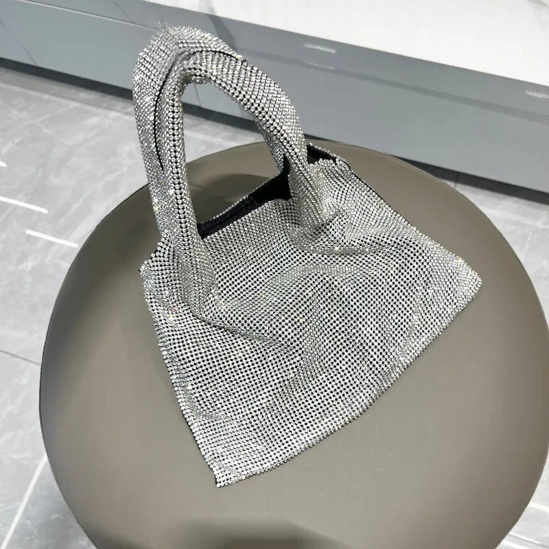 Silver cotton thread party handbag with rhinestone detailing and open outer pocket