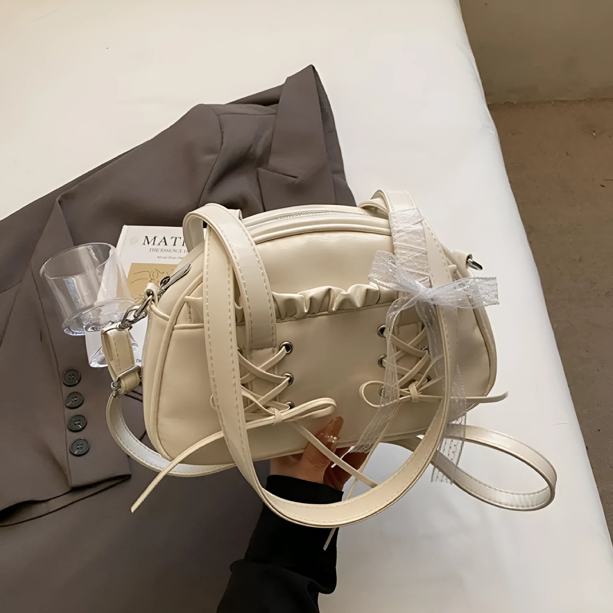 Women's bandage bow handbag in PU leather with phone compartment and sewing thread detail