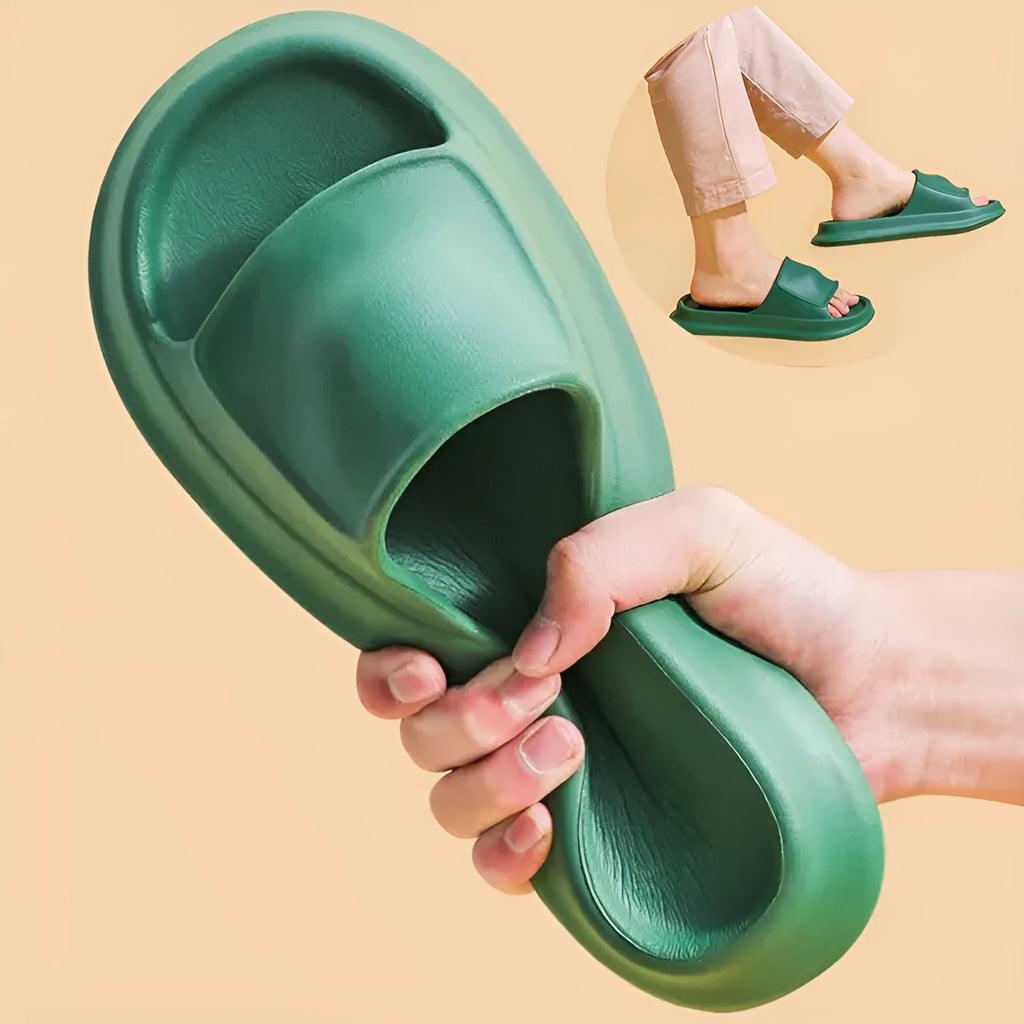 Pair of thick-soled EVA flip-flop slippers in a chosen colour on a bathroom floor.