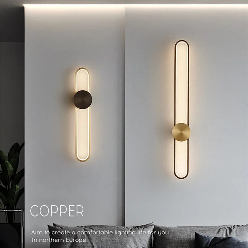 Round minimalist iron wall lamp with warm white LED light in black or gold finish.